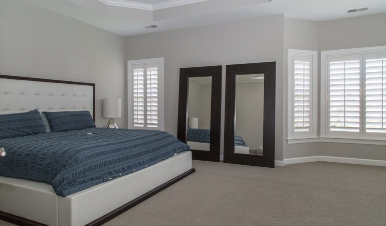 White shutters in a minimalist bedroom in Boston.